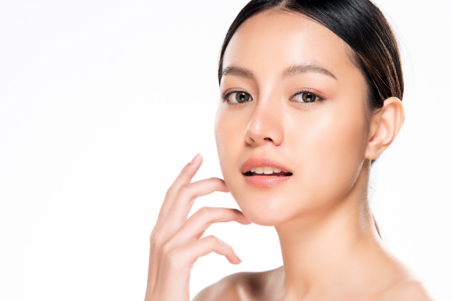 Beautiful Young Asian Woman with Clean Fresh Skin. Face care, Fa