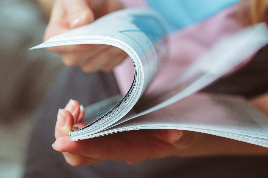 Woman reading magazine at home