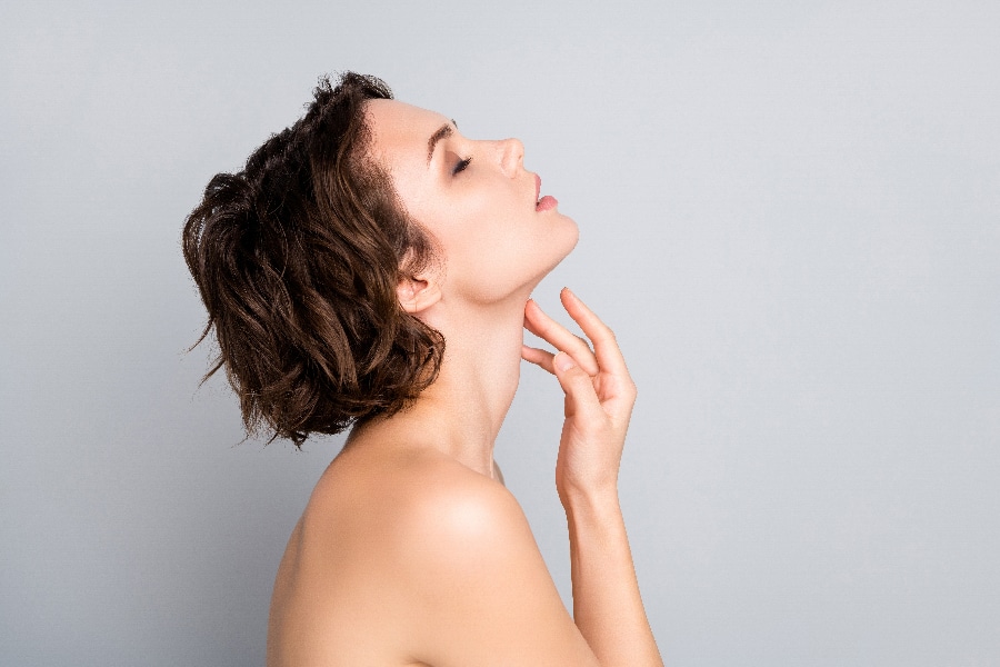 Closeup profile photo of attractive beautiful naked lady bob short hairstyle sensual aesthetic beauty touch hand arm silky neck skin eyes closed isolated grey color background