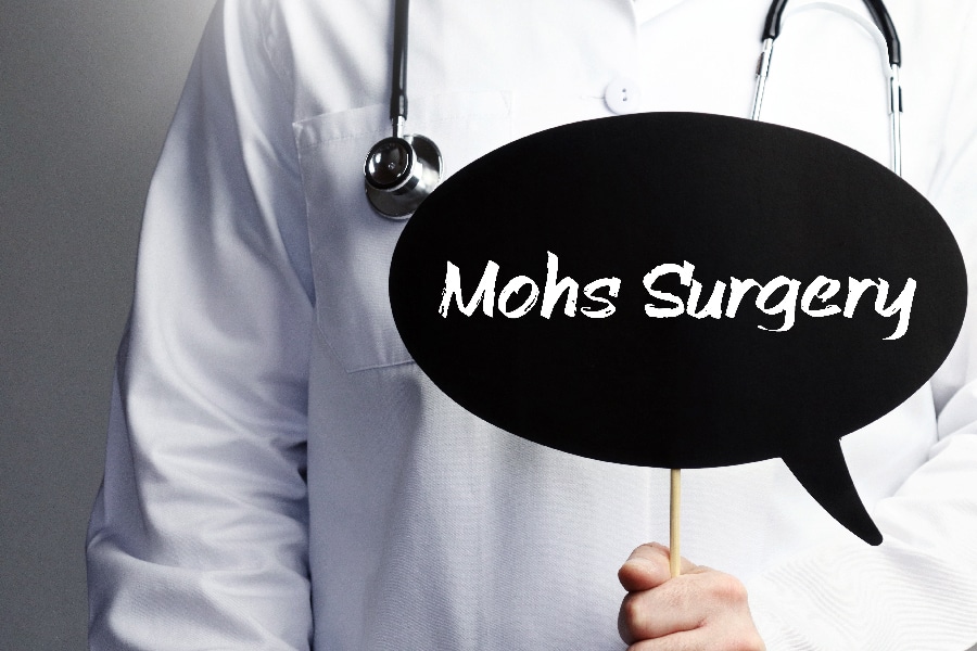 Mohs Surgery. Doctor with stethoscope holds speech bubble in han