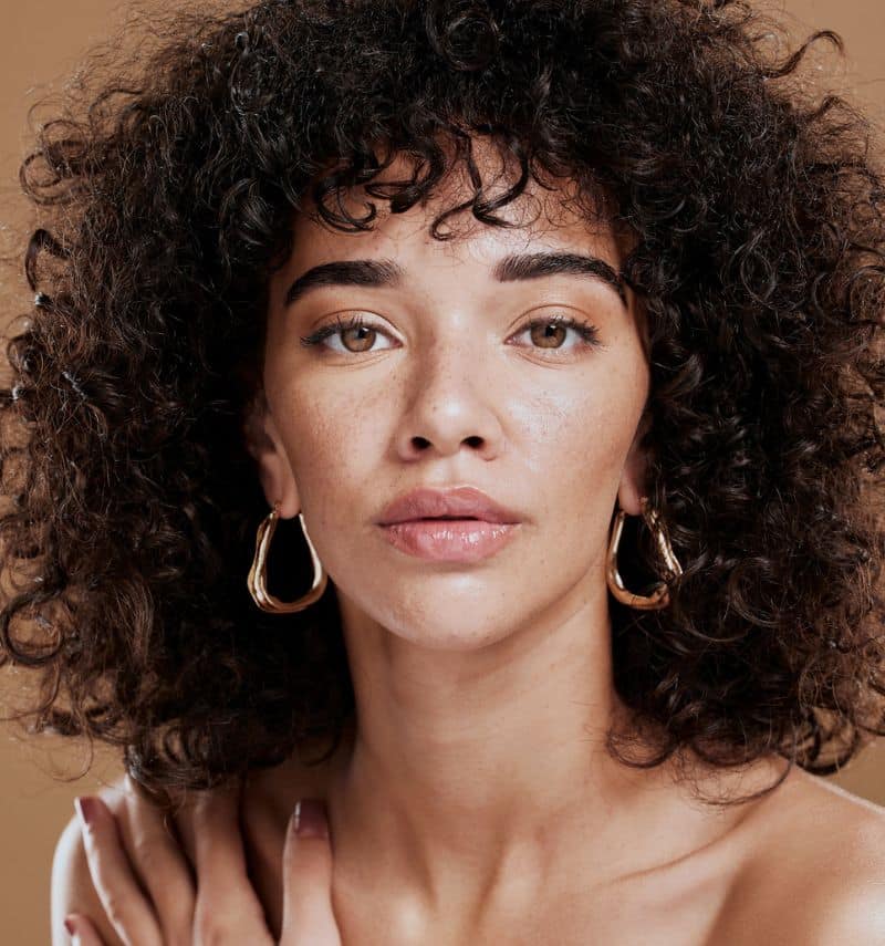 beautiful natural young woman with curly hair