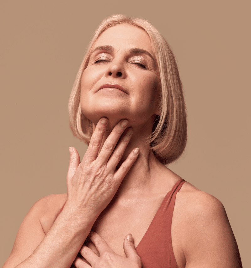 middle aged woman touching her chin middle aged woman touching her chin