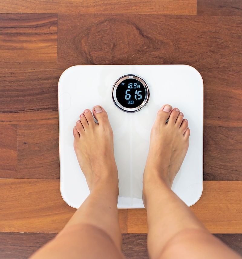 woman standing on scale woman standing on scale