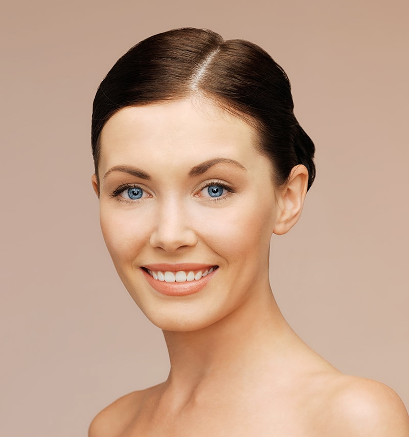 Woman smiling with clear skin and bright eyes. Woman smiling with clear skin and bright eyes.