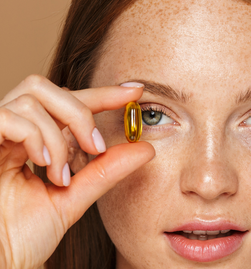 woman holding a vitamin